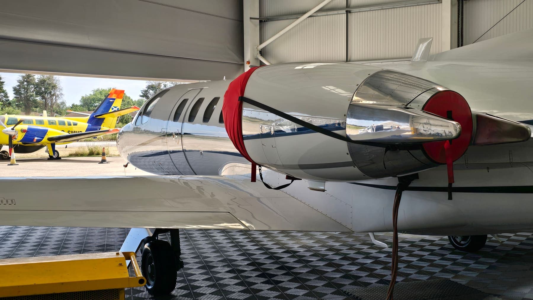 Mirror-polished engine inlet brightwork on a Citation, reflecting the apron