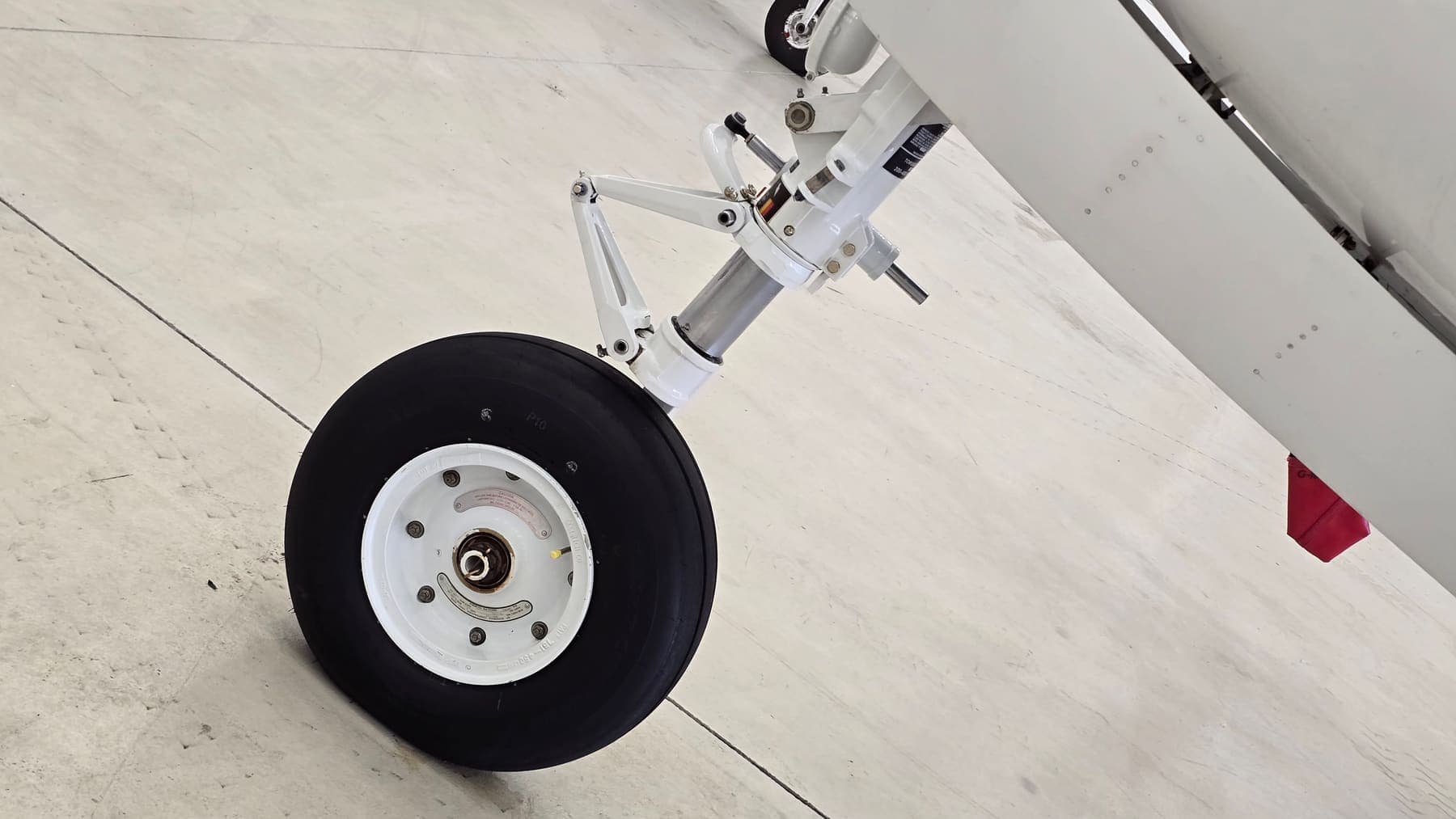 King Air main landing gear cleaned and degreased — wheel, strut and linkages brought back to white