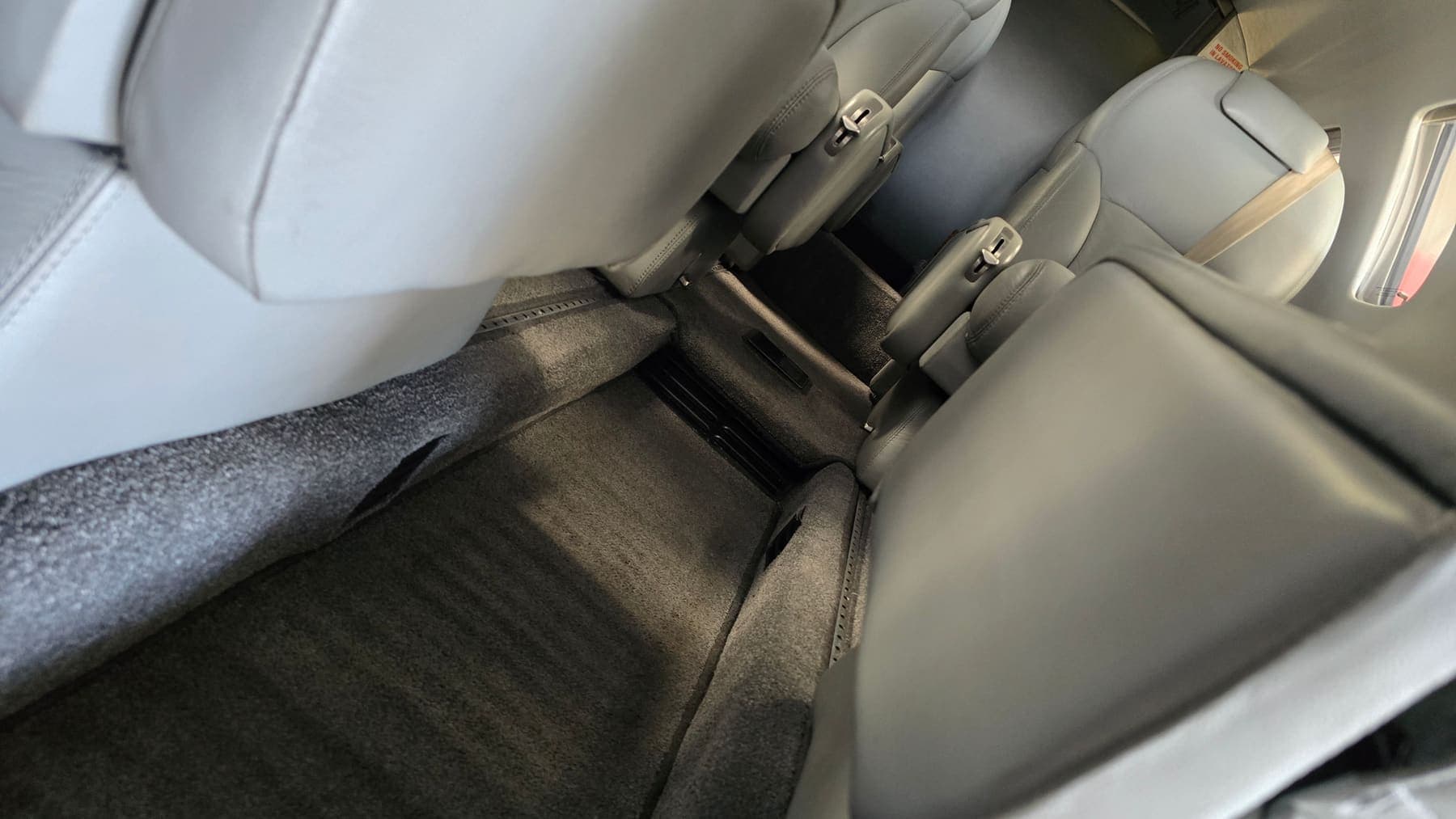 Freshly cleaned cabin carpet between the club seats of a charter Citation